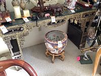 Front view of side table showing drawer, open shelf, and two-door cabinet with gold-painted details