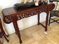 Front view of table showing full carved apron and legs