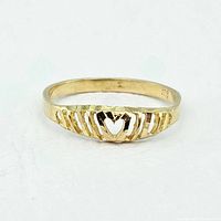 Front view of delicate 10K yellow gold ladies ring with heart and vertical cutouts