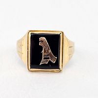 Front-facing view of ring showing black inset and raised letter A