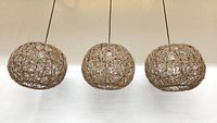 Three wicker pendant lights hanging side by side, showing overall shape and size.