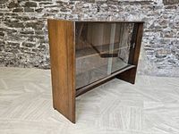 Frontal angle of walnut hutch showcasing glass sliding doors, interior shelves, and shape.