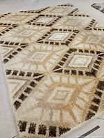 Photo showing the overall view of the large shag rug with diamond pattern and muted earth tones.