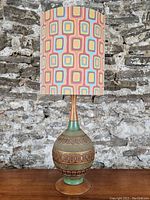 Full front view of lamp showing base, neck, and shade