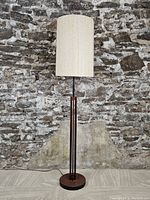 Full view of lamp against stone background