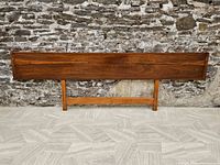 Full front view of headboard leaning against stone wall