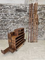 Overview of all uprights leaning against wall and stacked shelf modules and planters on dolly