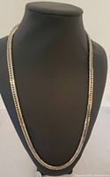 Photo of the full silver tone Sherman chain necklace displayed on a black bust, showing its length and reflective polished flat links.