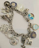 Full view of the silver charm bracelet showing all charms attached.