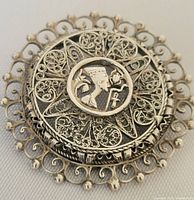 Front view showing detailed filigree and Egyptian motif.