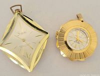 Photo of two vintage pendant watches, one Sheffield and one Secila, front view showing dials and cases.