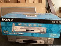 Sony SLV-N700 Video Cassette Recorder VHS Player with original blue box showing branding and model info.