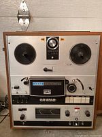 Front view showing dual reel tables, control panel and wood cabinet