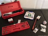 Craftsman rotary tool laid out with many small tool bits, hammer, and accessory parts on black surface