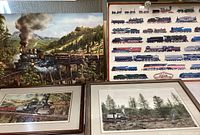 Four framed locomotive art pieces arranged together showing various steam locomotives in scenic outdoor settings.
