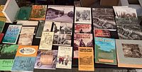 Overhead view of two rows of books showing titles on logging, timber, railroads, and regional history