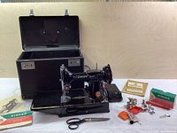 Overview of sewing machine, case, foot pedal, manual and accessories