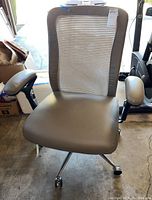 Front view of office chair showing mesh back, padded seat and armrests, chrome swivel base with wheels.