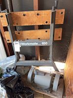 Workmate 100 bench showing the front metal frame and wood panels in folded position with electric sander below.