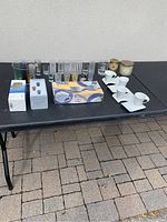 Full view of table with various shot glasses, espresso cups, and boxed glassware sets