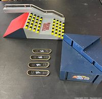 Two Tech Deck fingerboard platforms and four wooden decks arranged on table