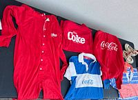 Photo showing red Coca Cola thermal pajamas, sweatshirts and rugby shirt along with high tops sneakers.