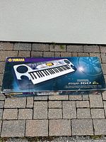 Original box of Yamaha PSR-160 keyboard with product image and branding on the top side