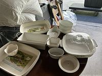 Overview of assorted white kitchenware including baking dishes, bowls, and serving tray