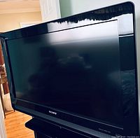 Front view of Sony 32-inch flat-screen TV with black bezel and screen off.
