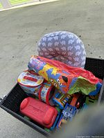Full lot view with pillow, toys including drum, Elmo item, and other colorful toys in basket