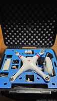 Open foam-lined hardshell case showing drone frame, battery and foam inserts