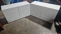Both dressers angled side by side on concrete floor