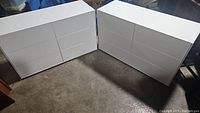 Both dressers side by side on concrete floor