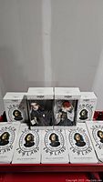 Full view of 11 Madame Tussaud's Pageant of History dolls in original packaging, some boxes showing the Peggy Nisbet Doll theme and historical figure dates 1761-1850 England.