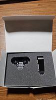Radar detector module and mounting clip seated in foam insert of original box