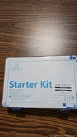 Closed white plastic case labeled 'Starter Kit' by Freenove with sticker showing kit details.