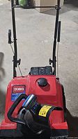 Front view showing red housing, chute and auger assembly