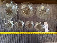 Overview of all 7 pieces: 1 large serving bowl, 2 medium bowls, 4 nappies lined up with tape measure for scale