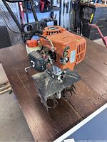 Front side view of Echo tiller showing engine, blade area and housing.