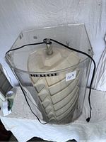 Front view of the acrylic jewelry display case with power cord and 14K Gold label visible.