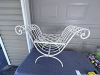 Front view of white steel vanity chair with lattice seat and decorative scroll arms.