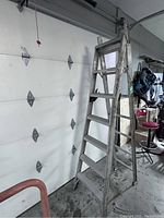 Aluminum 7 ft step ladder side view showing steps and locking mechanism.