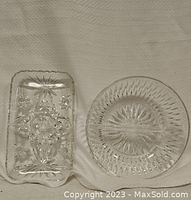 Top-down view of two crystal glass dishes on cloth background, showing rectangular and round shapes with cut patterns