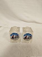 Pair of two clear square glass salt and pepper shakers with skier decal from 3 Valley Gap Canada, 2 inches tall