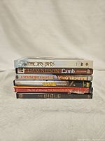 Stack of six DVD cases with titles visible on the spine showing religious or spiritual movie themes