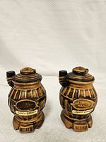 Two brown stove-shaped ceramic salt and pepper shakers standing upright on a white background labeled 'Canada' and 'Banff Canada'.
