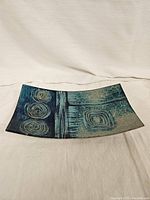 Top-angle view of the decorative plate showing overall shape, design, and color patterning.