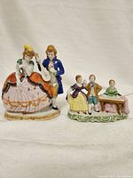 Front view of the two porcelain figurines, showing a dancing couple and three musicians.