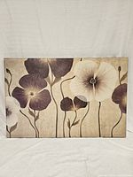 Front view of the beige and burgundy floral canvas painting showing large stylized flowers on beige background.
