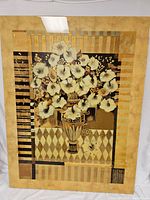 Front view of the large artwork showing the floral arrangement in a vase with gold toned borders and geometric patterns.
